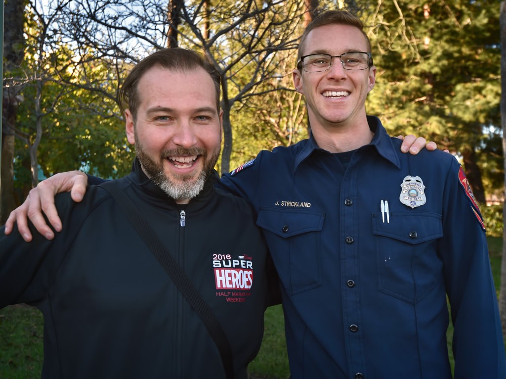 Cardiac arrest survivor Jonathan Hika, left, with AF&R Firefighter/Paramedic John Strickland III a year after helping to revive him during the race last year. Photo by Steven Georges/Behind the Badge OC
