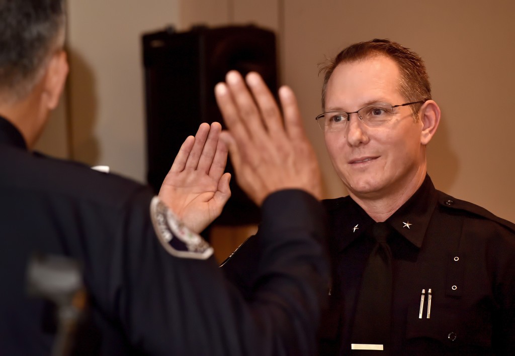 Mark Lauderback is sworn in as commander by Westminster Police Chief Roy Campos during a promotion ceremony. Photo by Steven Georges/Behind the Badge OC