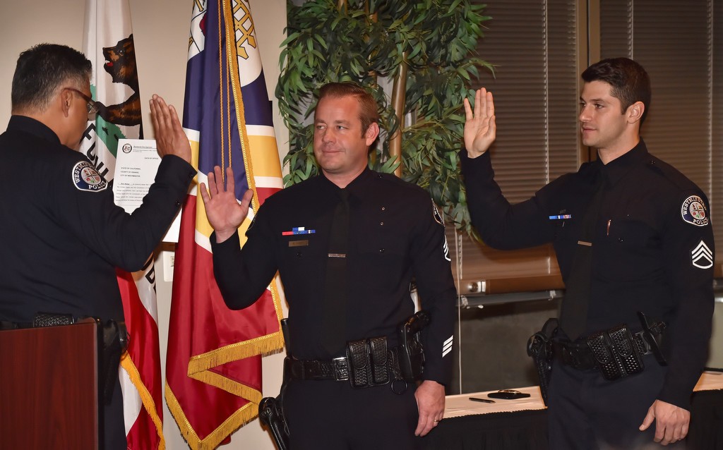 Sgt. Ron Weber and Sgt. Anil Adam, right, are sworn in to their new rank by Westminster Police Chief Roy Campos during a promotion ceremony. Photo by Steven Georges/Behind the Badge OC