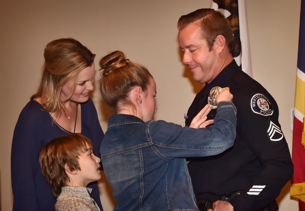 Sgt. Ron Weber has his new badge pinned to him by his daughter, Alexa Weber, 11, with his wife Lisa Weber and 8-year-old son Mason Weber standing next to him during a Westminster PD promotion ceremony. Photo by Steven Georges/Behind the Badge OC