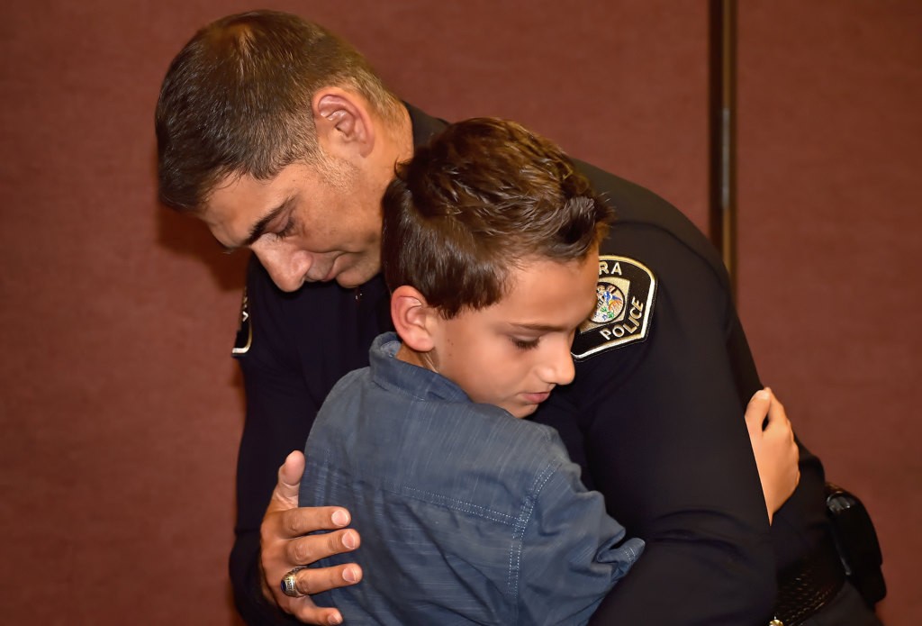 Capt. Dean Capelletti gets a hug from his son, Nikolas Capelletti, 10, after receiving his new captains badge during LHPD’s promotion ceremony. Photo by Steven Georges/Behind the Badge OC