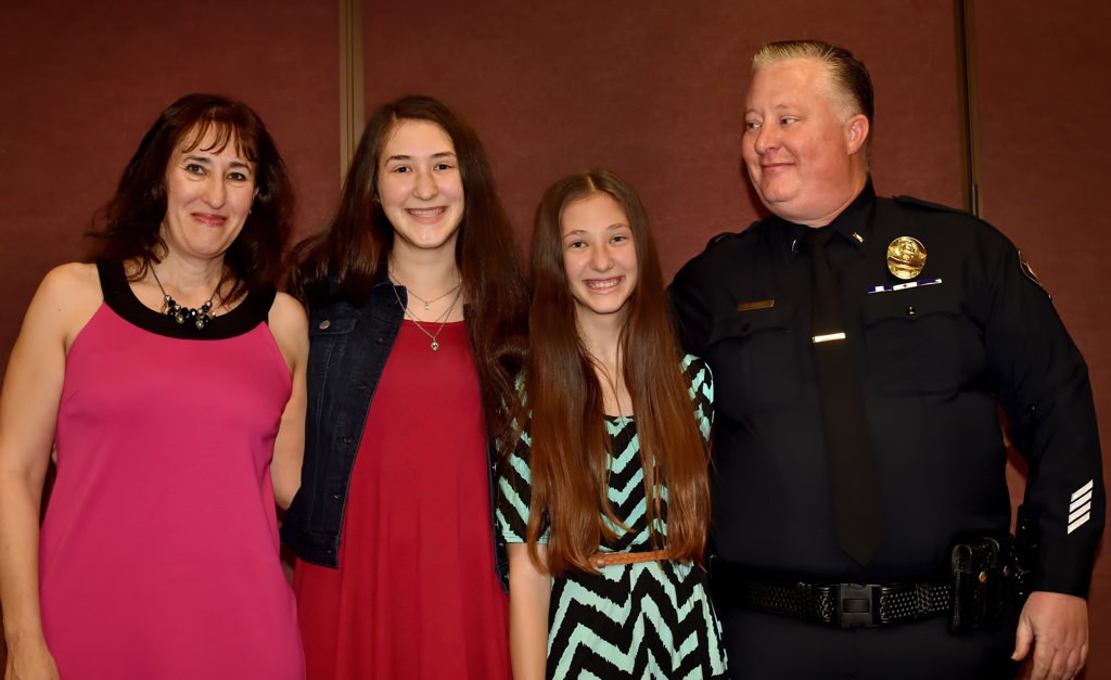 Lt. Clint Angle stands with his family that includes his wife, Pam Angle, left, Nicky Angle, 16, and Amanda Angle, 13, after receiving his new badge during LHPD’s promotion ceremony. Photo by Steven Georges/Behind the Badge OC
