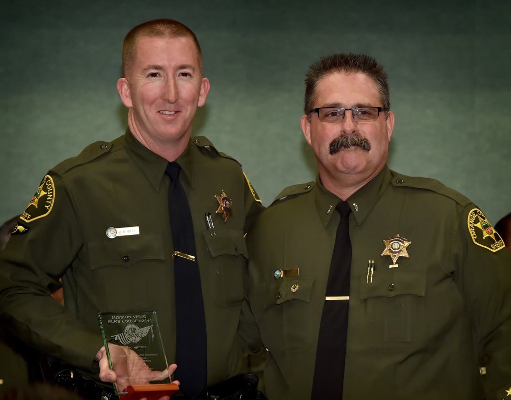 OCSD Bryan Robins (Laguna Niguel), left, receives the Meritorious Service Award from Lt. Matthew Barr. Photo by Steven Georges/Behind the Badge OC