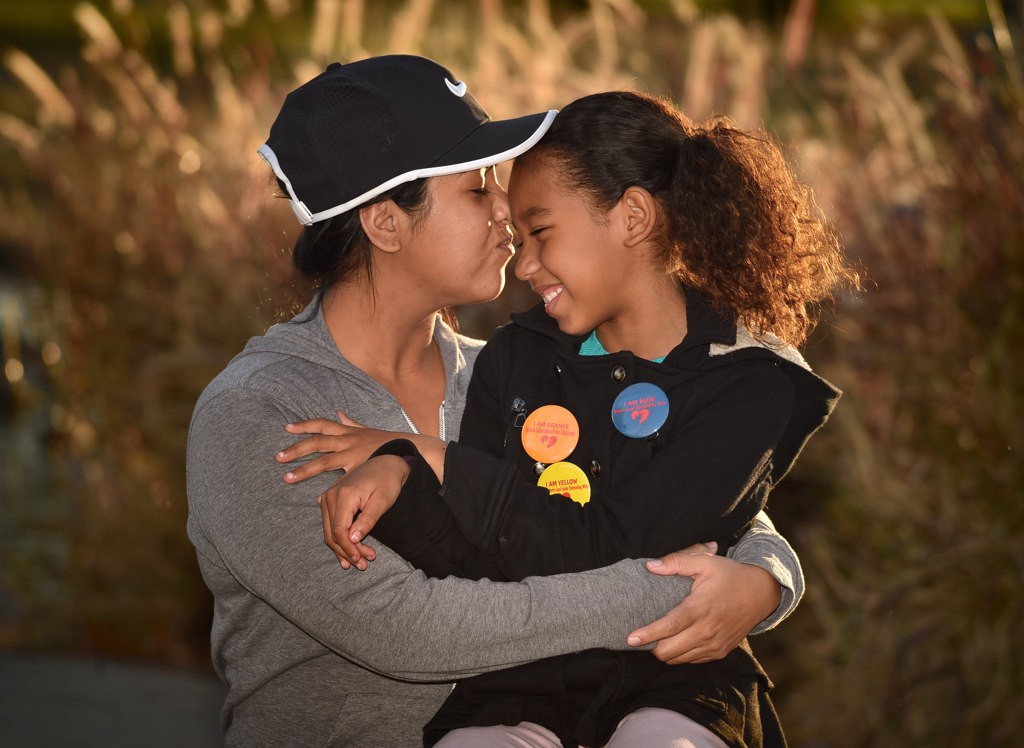 Alyssa Castille, 9, with her mother Loraine Castille. Photo by Steven Georges/Behind the Badge OC