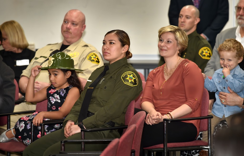Family and friends of six new lateral deputies joining the Orange County Sheriff Department, including Deputy Melinda Reyna and her 7-year-old daughter Olivia Torres, left, attend the swearing in ceremony at the OCSD Brad Gates Building in Santa Ana. Photo by Steven Georges/Behind the Badge OC