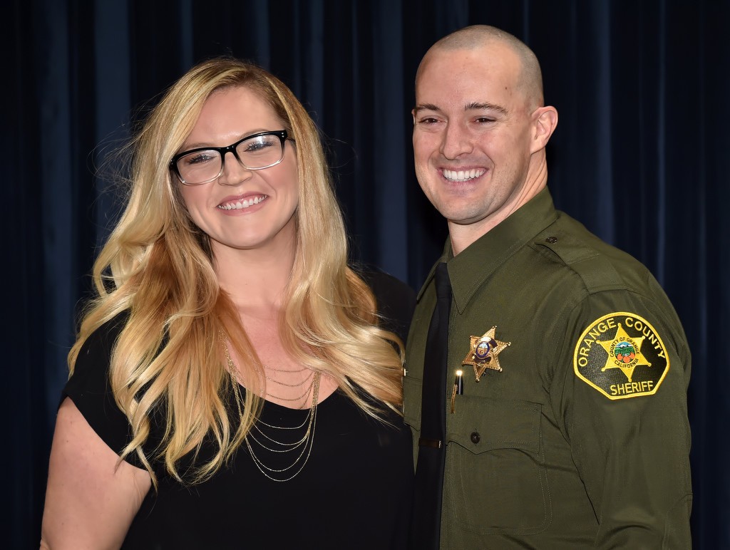 OCSD Deputy Arthur Paine smiles with his wife, Audra Paine, after receiving his new badge during a swearing in ceremony for laterals. Photo by Steven Georges/Behind the Badge OC