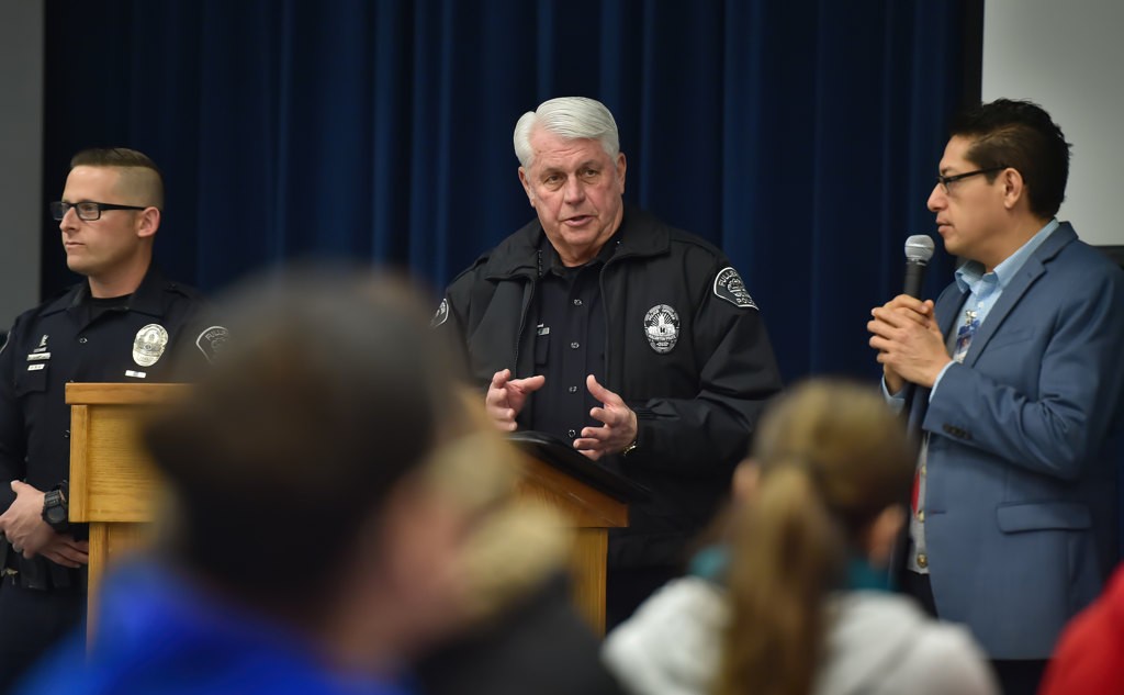 Fullerton Police Chief David Hinig asks parents at Pacific Drive School to trust that they will not be handed over to the US Immigration Service if they ask the police for help. Next to him is Sgt. Jon Radus, left, and Carlos Perez who helped out as a translator. Photo by Steven Georges/Behind the Badge OC