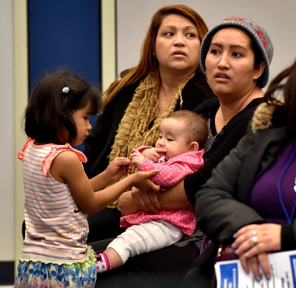 Four-year-old Heidi Moralis tends to 5-month-old Ariel Serrato during a community meeting Fullerton PD had for the parents at Pacific Drive School in Fullerton. Photo by Steven Georges/Behind the Badge OC