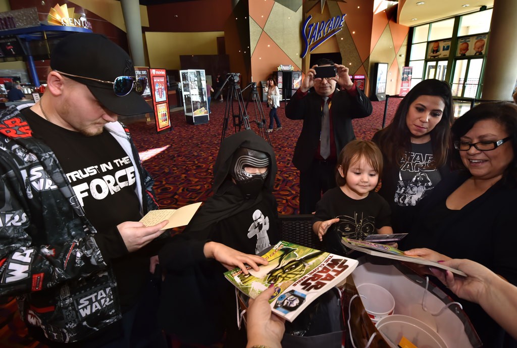 OPD PD Officer Sharif MuzayenÕs kids, Leia and Luke, receive Star Wars gifts from theater management at Century Stadium 25 and XD theaters in Orange before going to see the new Star Wars movie, Rogue One, during a special showing for him. Other Star Wars gifts were given by the Disney studios. Photo by Steven Georges/Behind the Badge OC