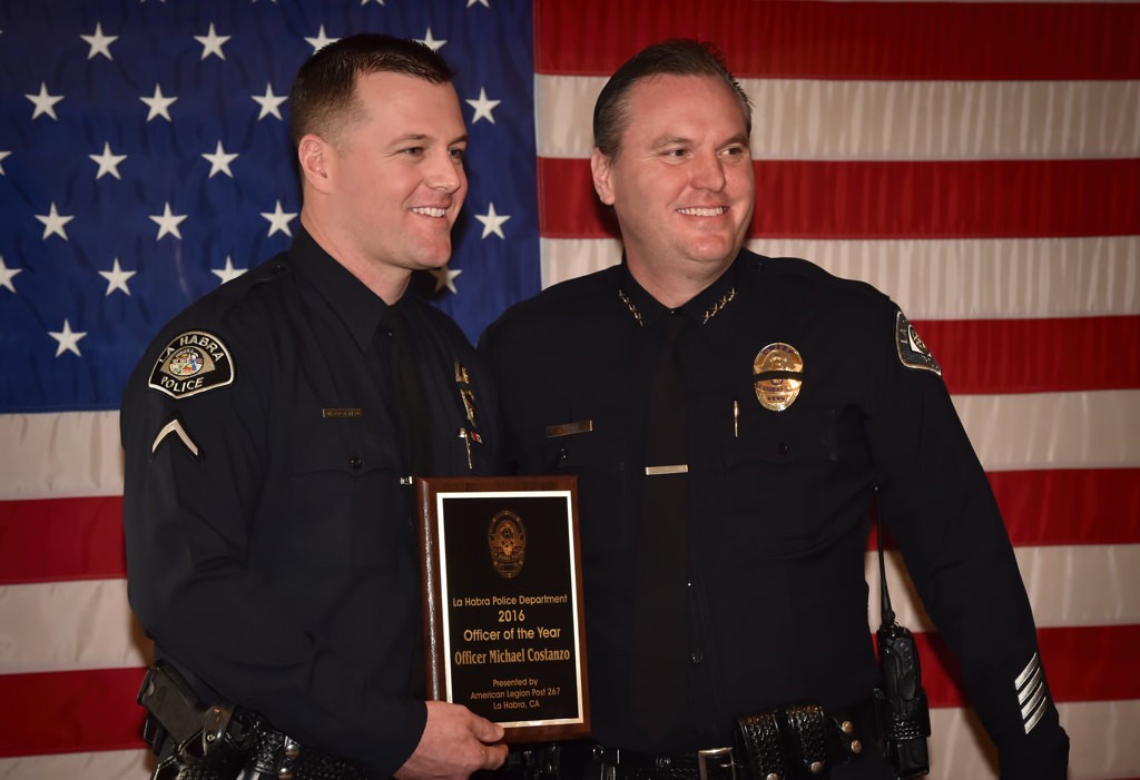 La Habra Officer Michael Costanzo, left, accepts the 2016 Officer of the Year award, sponsored by American Legion Post 267, from Police Chief Jerry Price. Photo by Steven Georges/Behind the Badge OC