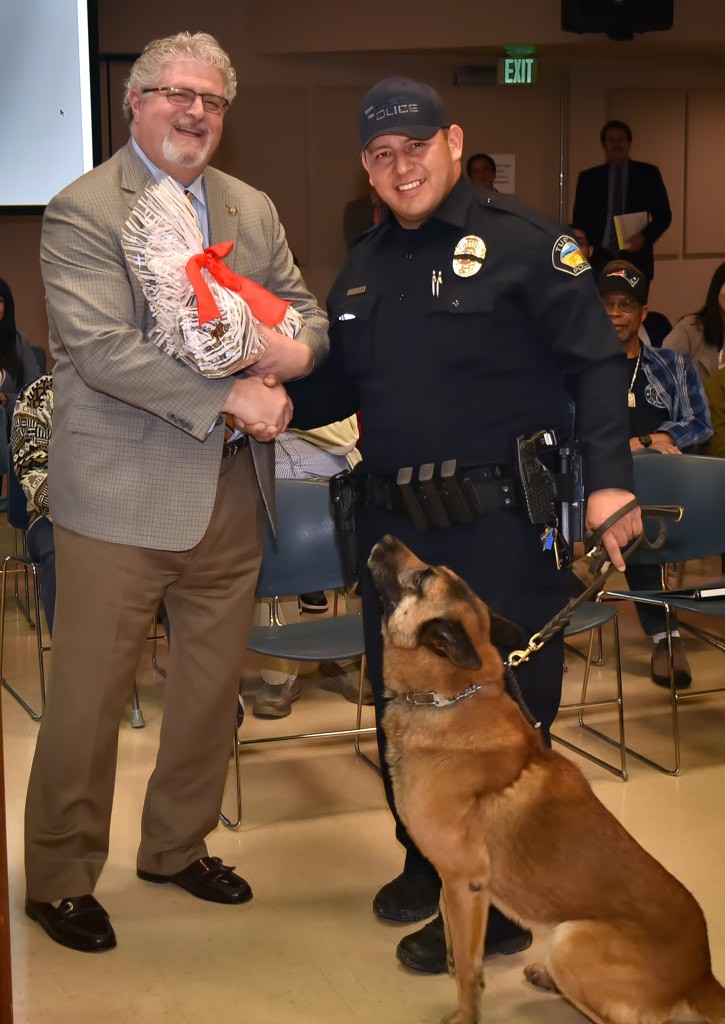 Tustin Mayor Allan Bernstein presents TPD Officer Rene Barraza’s K-9 partner, Bravo, a special treat during the K-9’s retirement ceremony. Photo by Steven Georges/Behind the Badge OC