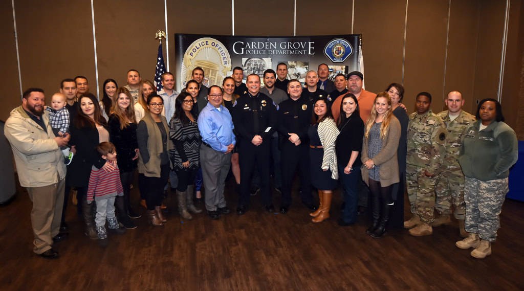 Garden Grove’s new PD Officer Kris Kelley stands with his family and friends during his swearing in ceremony. Photo by Steven Georges/Behind the Badge OC