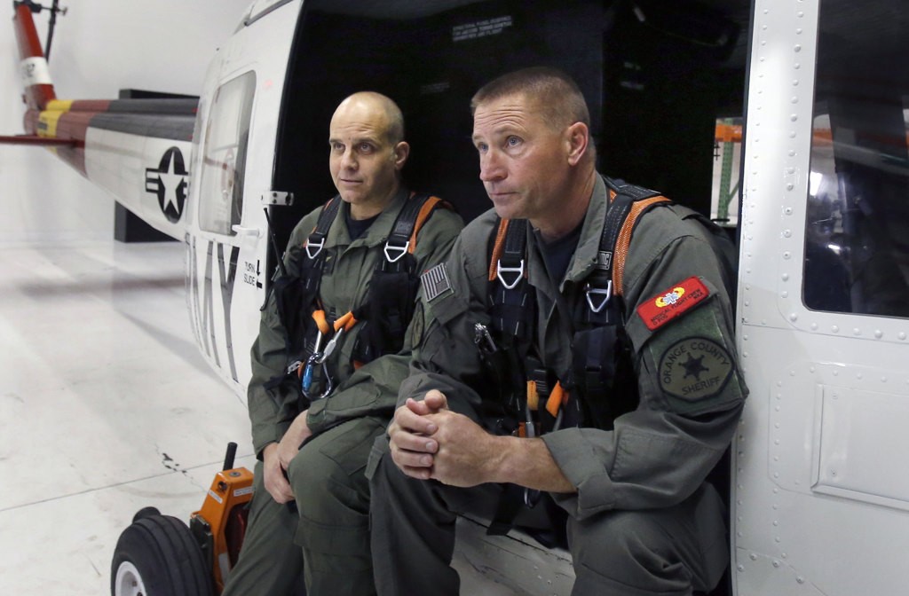 Michael De Laby and Jim Slikker in one of the Orange County Sheriff's Department's helicopters which was recently donated. Photo by Christine Cotter