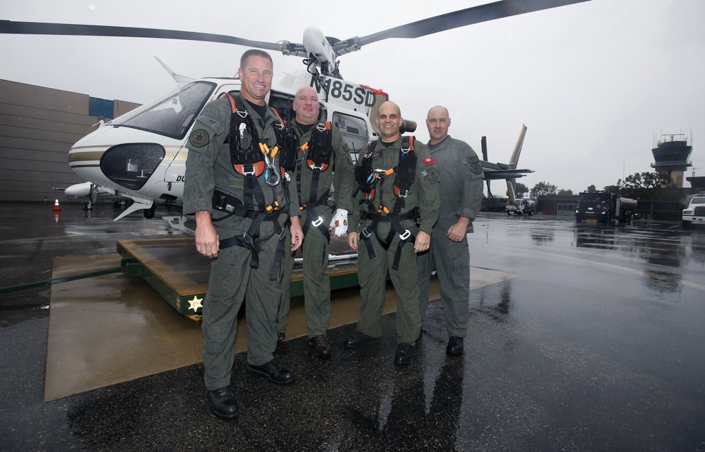 Orange County SheriffÕs Department helicopter crew members, Jim Slikker, Joe Kantar, Michael De Laby, and R.J. Garwood, with one of their search and rescue helicopters stationed at John Wayne Airport. Photo by Christine Cotter