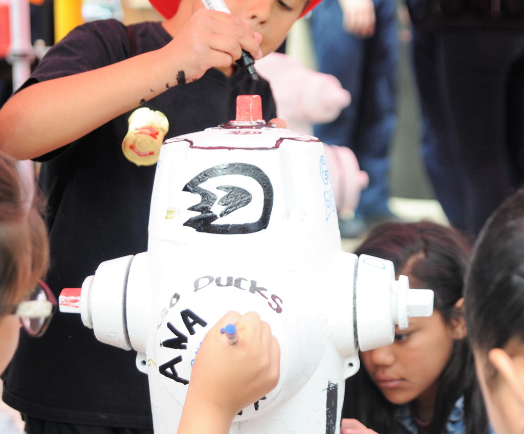 Youngsters from three Anaheim youth groups created works of art from old fire hydrants during an event hosted by Anaheim Fire & Rescue on March 4. The painted hydrants will then be auctioned off and the proceeds will benefit each group. Photo by Lou Ponsi/Behind the Badge