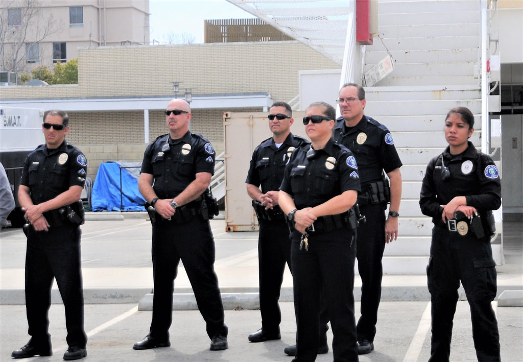 Costa Mesa police officers listen to speakers during a memorial service Friday at the Costa Mesa Police Station, commemorating the 30th anniversary of the March 10, 1987 on-duty deaths of officers Mike Libolt and Dave Ketchum.