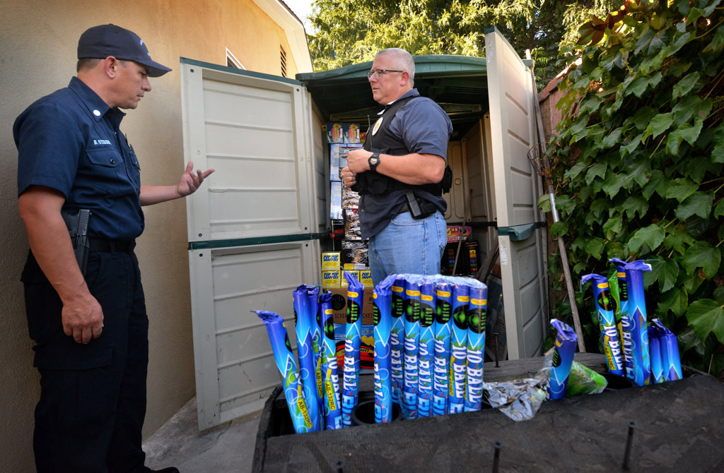 Garden Grove Fire Arson Investigators Bill Strohm, left, with Garden Grove Police Sgt. Carl Whitney next to a shed of illegal fireworks found at the home of 29-year-old Jonathan Salgado of Garden Grove. Photo by Steven Georges/Behind the Badge OC
