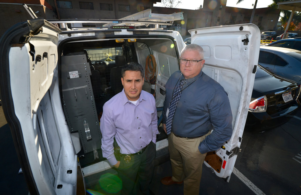 Detective Dennis Wardle, left, and Sgt. Carl Whitney of the Garden Grove PD shows shows the van used by serial burglars who targeted El Pollo Loco. Photo by Steven Georges/Behind the Badge OC