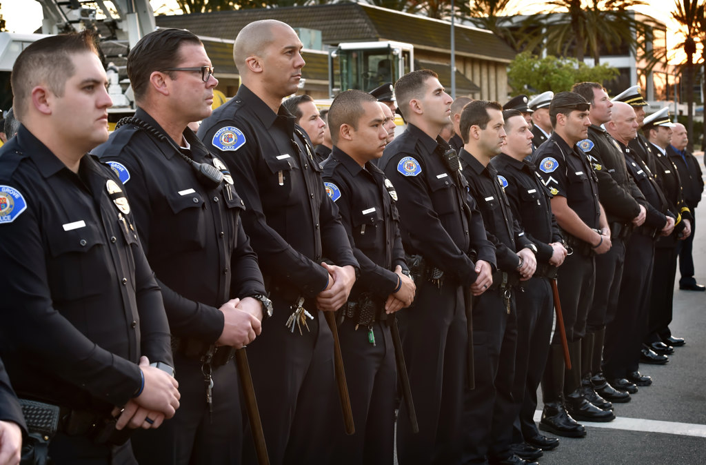 Garden Grove PD Officers line up to honor Whittier PD Officer Keith Boyer during a prayer vigil at the GGPD Police Officer Memorial. Photo by Steven Georges/Behind the Badge OC