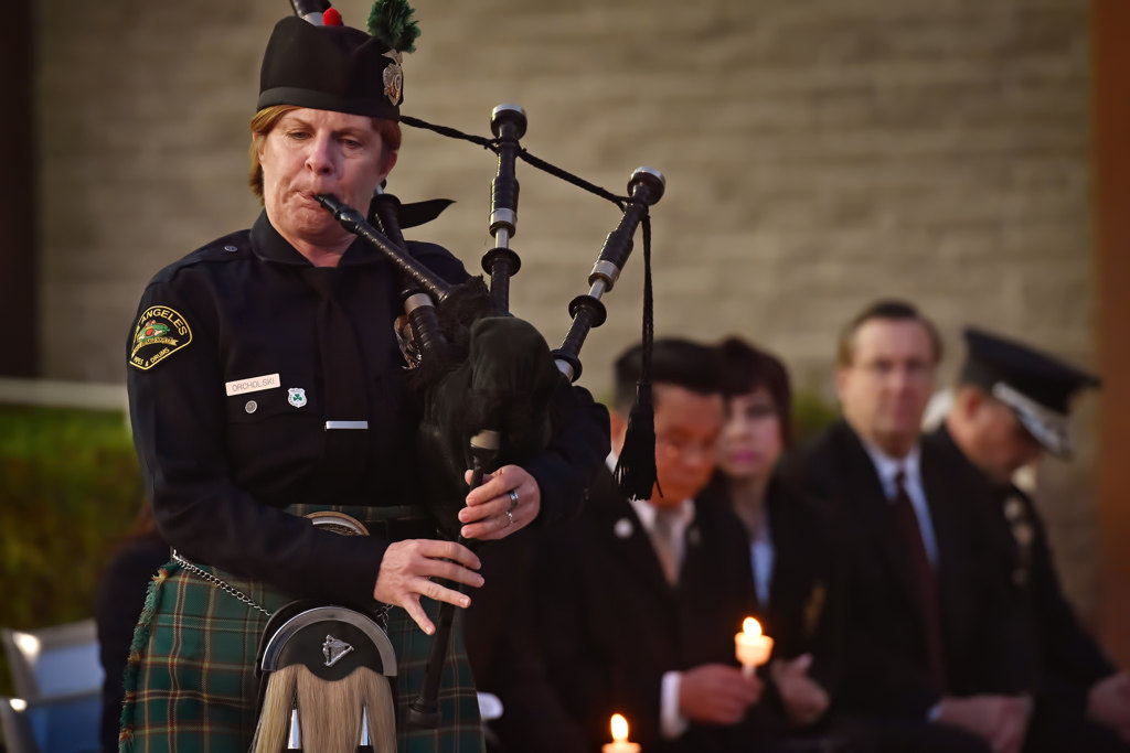Chrisy Geck-Orcholski, of the Los Angeles Police Emerald Society, plays Taps on the bagpipes at the conclusion a prayer vigil for Whittier PD Officer Keith Boyer at GGPD. Photo by Steven Georges/Behind the Badge OC
