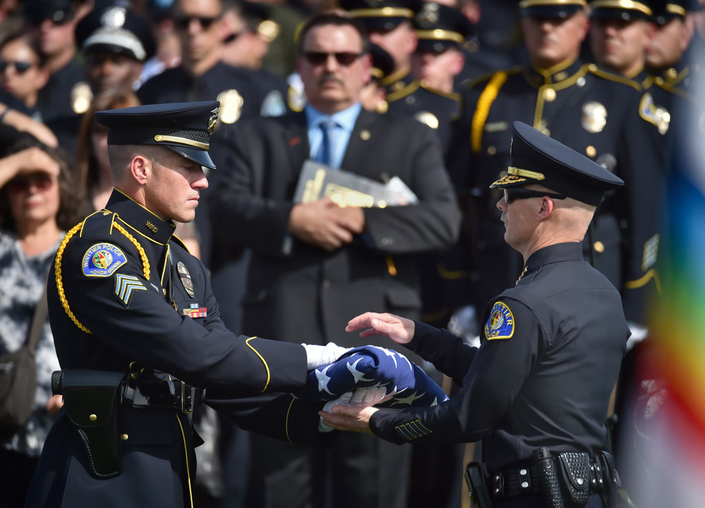 A Whittier PD honor guard presents the flag to Whittier Police Chief Jeff Piper, right, before presenting it to the family of Officer Keith Boyer. Photo by Steven Georges/Behind the Badge OC