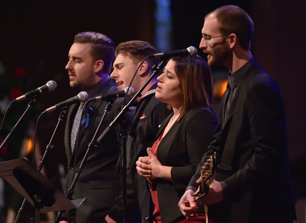 Joshua Boyer, left, Joseph Boyer, Ashley Sheleretis  and Mike Sheleretis sing Amazing Grace during a memorial service for their father, Whittier PD Officer Keith Boyer. Photo by Steven Georges/Behind the Badge OC