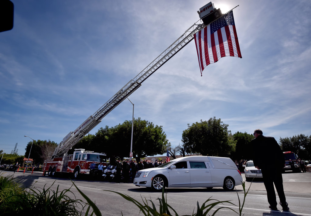 The hearse carrying Whittier PD Officer Keith Boyer drives out from Calvary Chapel Downey on its way to Rose Hills Memorial Park. Photo by Steven Georges/Behind the Badge OC