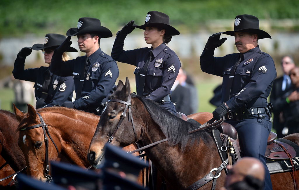 LAPD mounted officers salute during the playing of Taps at Rose Hills Memorial Park for Whittier PD Officer Keith Boyer. Photo by Steven Georges/Behind the Badge OC