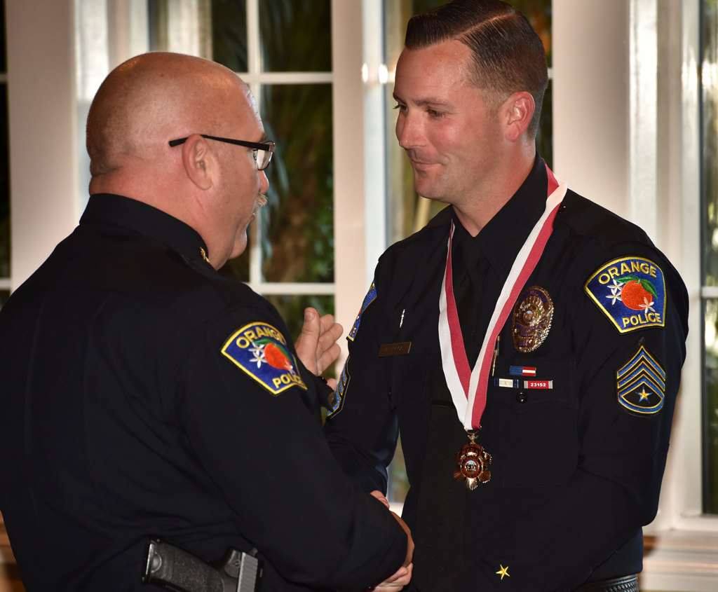 Orange PD Sgt. Kevin Plog receives the Life-Saving Medal from Orange Police Chief Thomas Kisela during an awards ceremony. Photo by Steven Georges/Behind the Badge OC