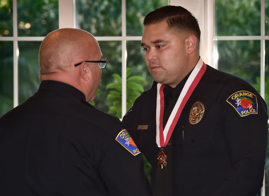 Orange PD Officer Jesse Ochoa receives the Life-Saving Medal from Orange Police Chief Thomas Kisela during an awards ceremony. Photo by Steven Georges/Behind the Badge OC