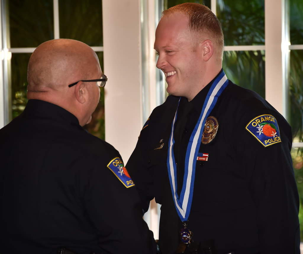 Orange PD Officer Daniel OÕNeil-Tennant receives the Medal of Distinction from Orange Police Chief Thomas Kisela during an awards ceremony. Photo by Steven Georges/Behind the Badge OC