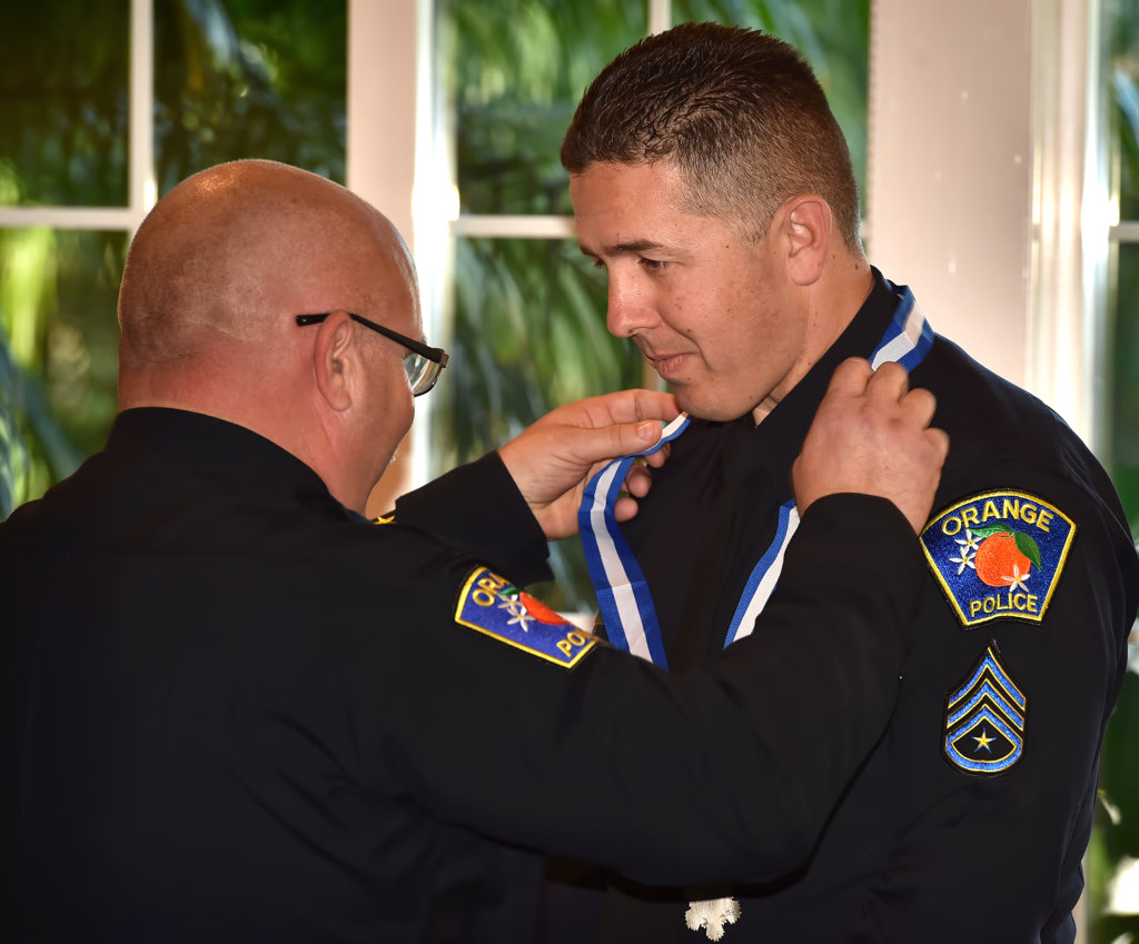 Orange PD Sgt. Phil McMullin receives the Medal of Distinction from Orange Police Chief Thomas Kisela during an awards ceremony. Photo by Steven Georges/Behind the Badge OC