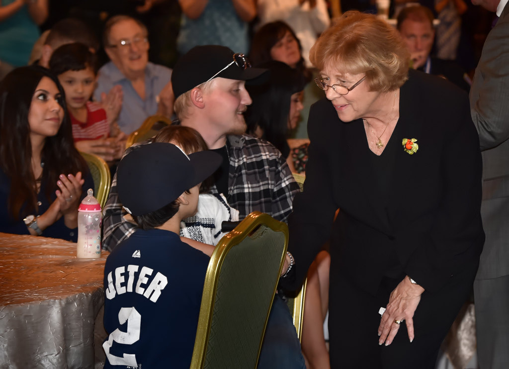 Orange Mayor Theresa Smith greets the family of Orange PD Officer Sharif Muzayen, including his son Luke, during a ceremony honoring those who helped save the life of Officer Muzayen. Photo by Steven Georges/Behind the Badge OC