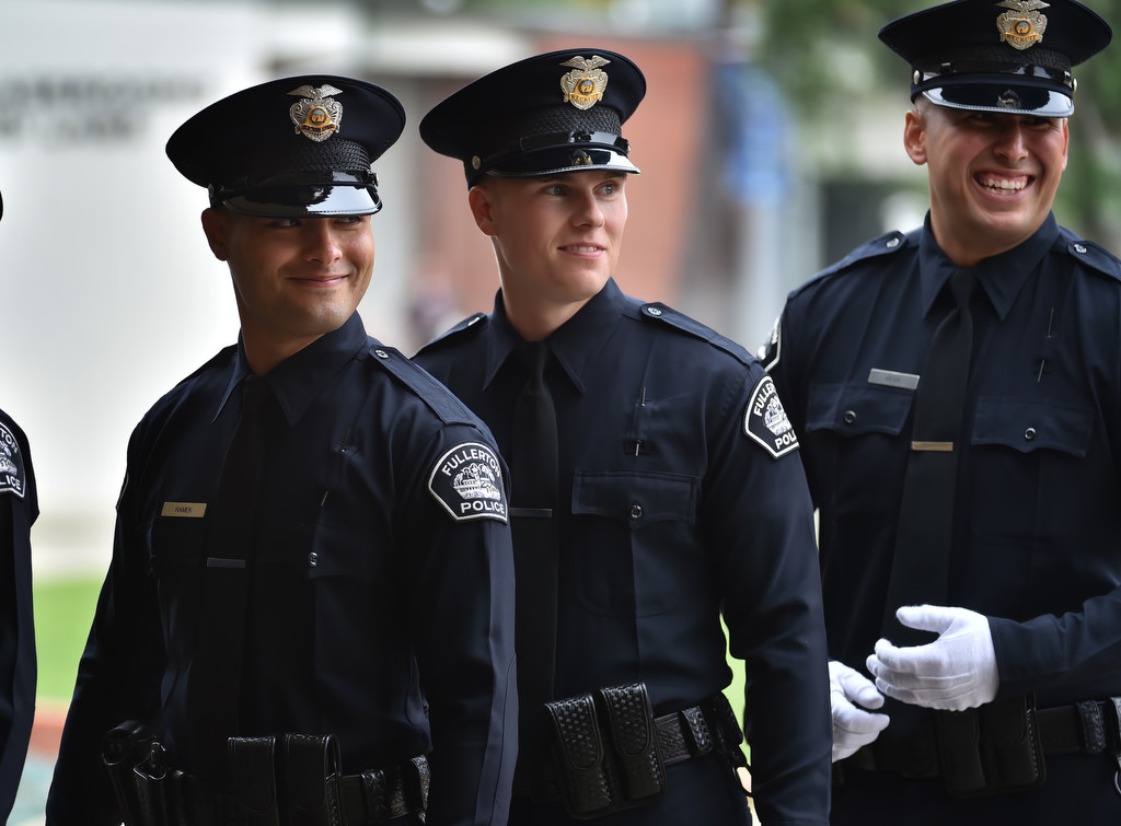 Fullerton PD Recruit Brandon Ramek, left, smiles before the start of police academy graduation ceremonies. behind him are Fullerton recruits Nolan Turner and Anthony Vega. Photo by Steven Georges/Behind the Badge OC