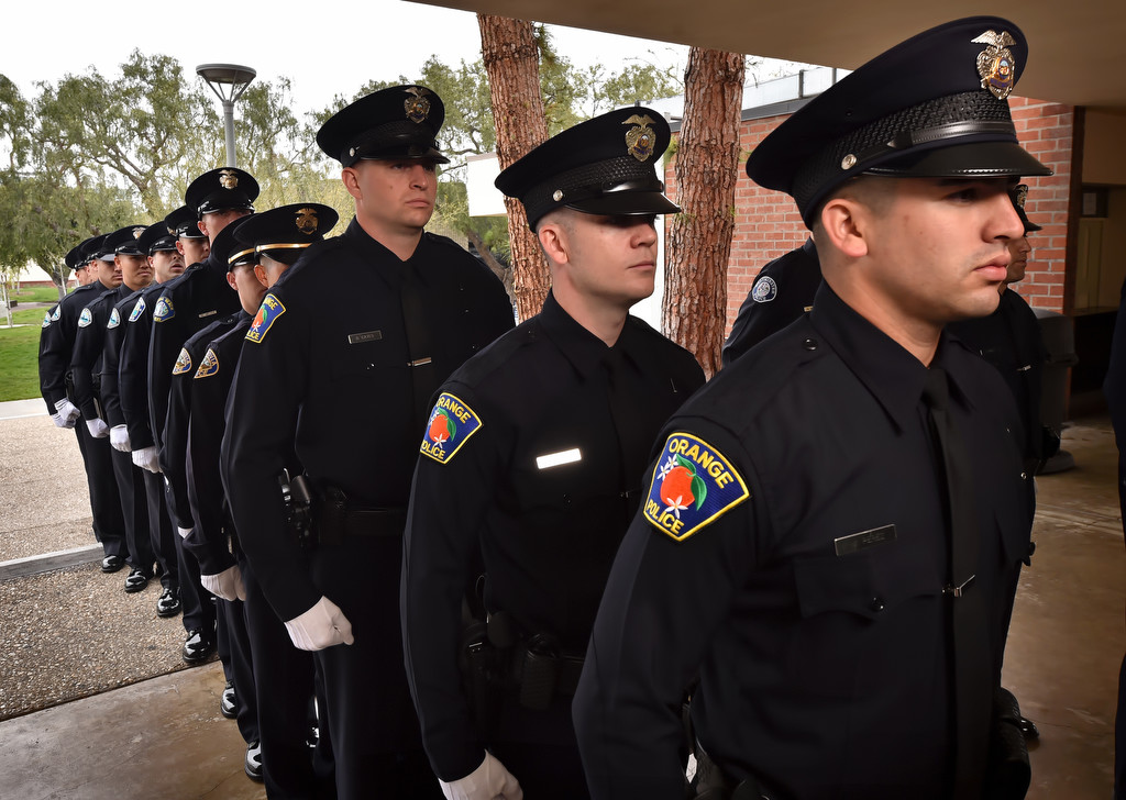 Orange PD recruits Mario Perez, front right, Benjamin Gilchrist and Greggory Cates enter the auditorium for the start of GWC police academy graduation ceremonies. Photo by Steven Georges/Behind the Badge OC