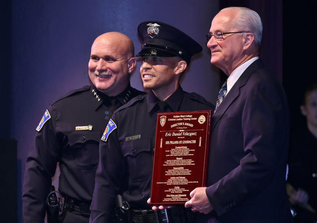 Orange PD Recruit Eric Velazquez, center, is presented the Director’s Award by Ron Lowenberg, dean/director of the GWC Criminal Justice Training Center, right, and Orange Police Chief Tom Kisela. Photo by Steven Georges/Behind the Badge OC