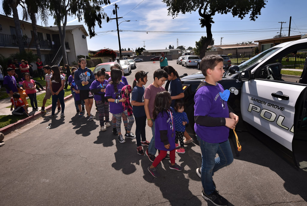 Kids lineup for their turn to tour a GGPD patrol car. Photo by Steven Georges/Behind the Badge OC