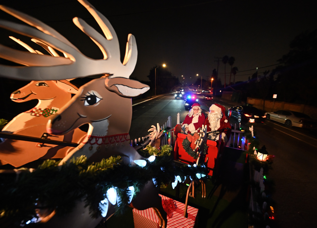 Santa and his police helpers visit every Tustin neighborhood Behind